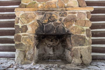 Old Fireplace. Stone fireplace cracked, dirty and in disrepair.