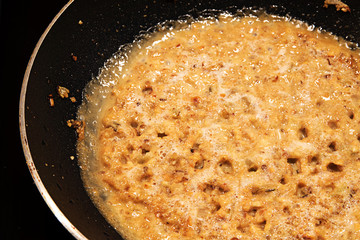 cooking Asian satay sauce with mashed peanuts and ingredients 