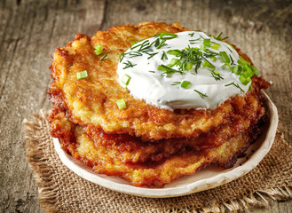 Potato pancakes on wooden table