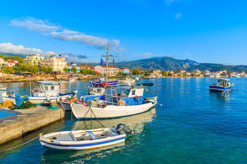 Naklejka na ściany i meble Greek fishing boats at sunrise in small port, Samos island, Greece
