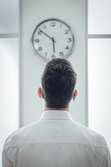 Businessman staring at the clock