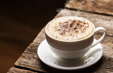 Close-up of coffee cup  on wooden background.
