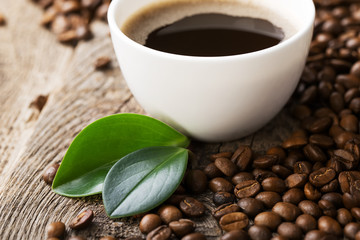 ground coffee in scoop and coffee beans on a wooden background,
