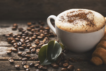 Hot coffee and pastries on a wooden background