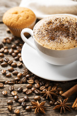 Hot coffee and pastries on a wooden background