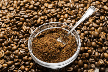Natural ground coffee heap in transparent glass bowl on сoffee