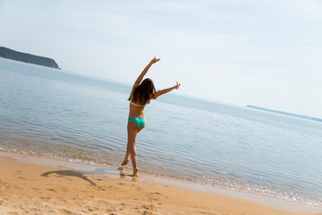 Happy young woman having fun on beach