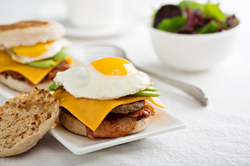 Breakfast burger with avocado, cheese and bacon