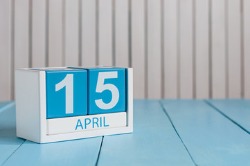 April 15th. Tax Day. Image of april 15 wooden color calendar on white background.  Spring day,...