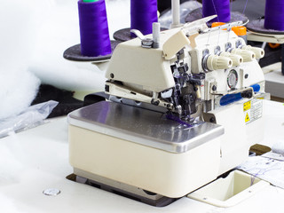 Five Thread Industrial Serger / Overlock Sewing Machine. An overlock is a kind of stitch that sews over the edge of one or two pieces of cloth for edging, hemming, or seaming