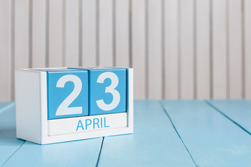 April 23rd. World Book Day. Image of april 23 wooden color calendar on white background.  Spring day, empty space for text