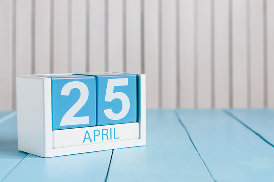 April 25th. International Day Of DNA. Image of april 25 wooden color calendar on white background.  Spring day, empty space for text
