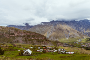 Fototapeta na wymiar Small houses on mountain background in Georgia
