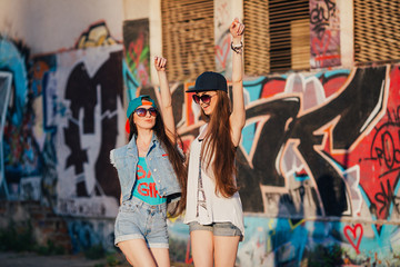 Fototapeta na wymiar two funny and happy street girls