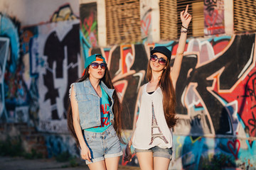 Fototapeta na wymiar two funny and happy street girls