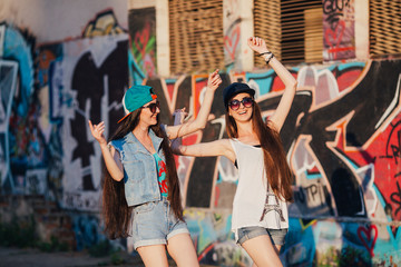 Obraz na płótnie Canvas two funny and happy street girls