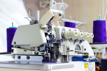 Five Thread Industrial Serger / Overlock Sewing Machine. An overlock is a kind of stitch that sews over the edge of one or two pieces of cloth for edging, hemming, or seaming