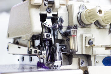 Five Thread Industrial Serger / Overlock Sewing Machine. An overlock is a kind of stitch that sews over the edge of one or two pieces of cloth for edging, hemming, or seaming