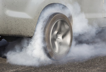 Drag racing car burns rubber off its tires