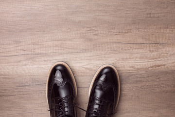 New pair of brogues shoes on a wooden background