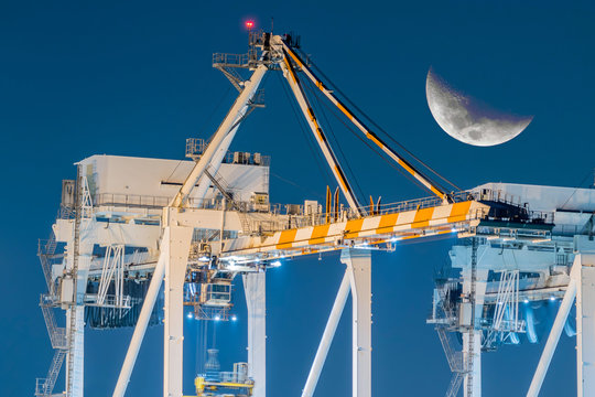 Crocs -Up Of Container Ships Being Unloaded At Night.