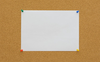 White paper on cork board