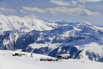 Fototapeta na wymiar Panoramic view on ski station on snowy mountains background