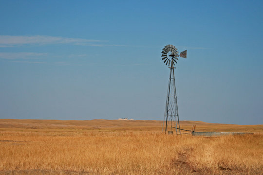 Windmill pumping water in Fairburn South Dakota between the east side of the Black Hills and the South Dakota Badlands