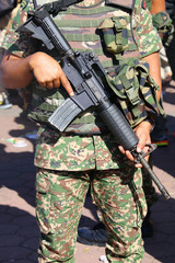 Military personnel with assault rifle