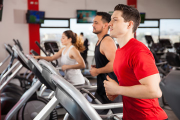 Fototapeta na wymiar Men and women jogging on a treadmill