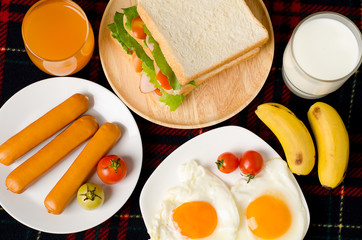 Breakfast,meal,fried egg,sandwich,sausage,orange juice,milk