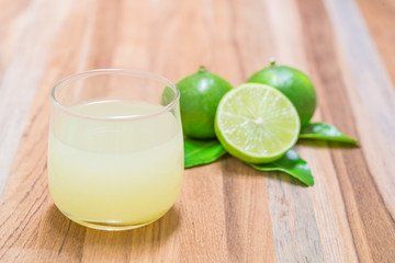 glass of lime juice with slice and leave