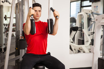 Fototapeta premium Young man exercising his chest muscles