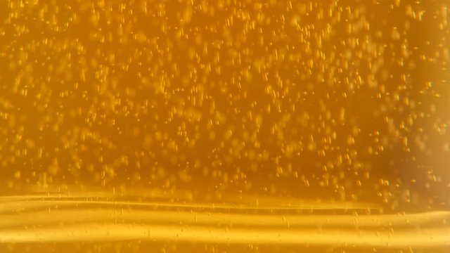 Slow tilting on glass full of beer bubbles and foam 4K 2160p UltraHD footage - Golden full color of fresh beer bubbles 4K 3840X2160 UHd video 