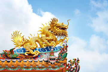 Golden dragon on blue sky, in chinese temple roof, Thailand, public places - non intellectual...