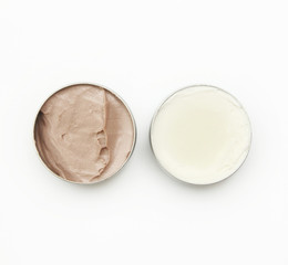 Top view of white and brown beauty creams