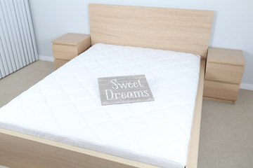 Bedroom interior with sign "sweet dreams"