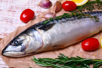 ingredients for baking scomber fillets, include raw mackerel, lemon, garlic, rosemary