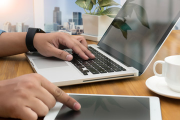designer hand working with stylus and digital tablet and laptop