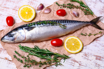 ingredients for baking scomber fillets, include raw mackerel, lemon, garlic, rosemary