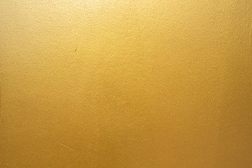 Gold concrete wall on background texture.