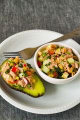 Avocado stuffed with tuna and fresh vegetables