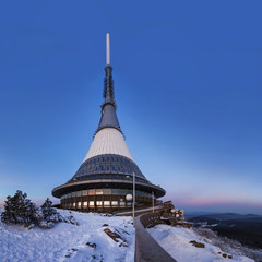 Transmitter and lookout tower in a winter landscape on the hill Jested.