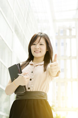 Young Asian woman thumb up