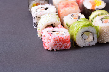 Sushi rolls on a black