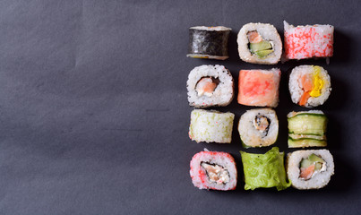 Sushi rolls on a black