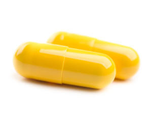 closeup of two yellow pills