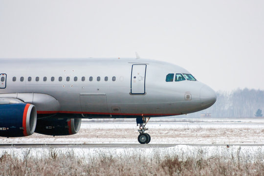 Taxiing aircraft in a cold winter airport