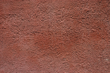 Texture of the old red paint on a small area of the surface