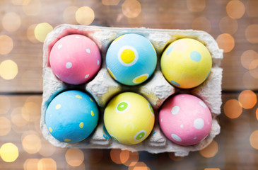 close up of colored easter eggs in egg box